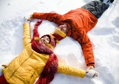 two people lying on the snow